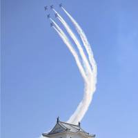 An ASDF aerobatics team soars over Himeji Castle in Hyogo Prefecture at a ceremony for the end of restoration work Thursday. The castle reopens to the public Friday. | KYODO