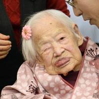 Misao Okawa, the world\'s oldest person, is wished a happy birthday by Takehiro Ogura, the chief of Higashisumiyoshi Ward, Osaka. Okawa turns 117 on Thursday. Guinness World Records recognized her in 2013 as the world\'s oldest woman. | KYODO