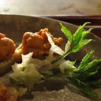 Tempura of koshi-abura (a wild herb) with fresh uni (sea urchin) at Tempura Matsu. | ROBBIE SWINNERTON