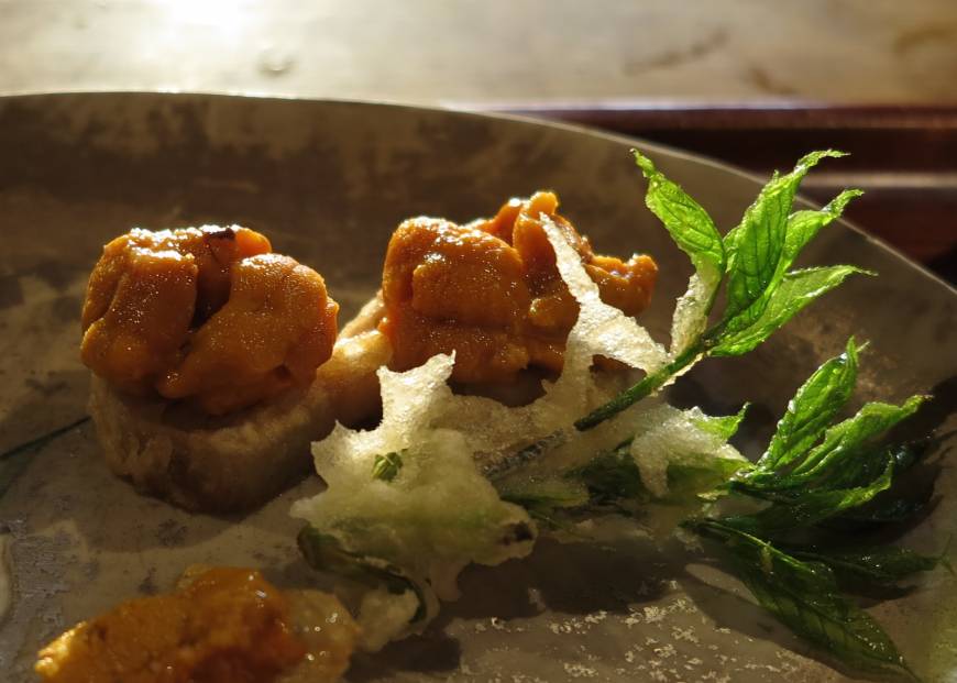 Tempura Matsu Tempura of koshi-abura (a wild herb) with fresh uni (sea urchin) at Tempura Matsu. | ROBBIE SWINNERTON
