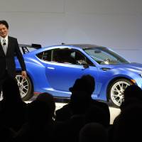 Tom Doll (left), president and chief operating officer for Subaru of America,and Yoshio Hirakawa, president of Subaru Tecnica International, unveil the Subaru BRZ on Wednesday at the 2015 New York Auto Show at the Javits Center in New York.  | AFP-JIJI