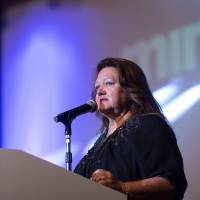 Billionaire Gina Rinehart, chair of Hancock Prospecting Pty, speaks during the Mines and Money conference in Hong Kong on March 26. Despite the slump in iron ore prices, she is ready to revive a massive iron ore project. | BLOOMBERG
