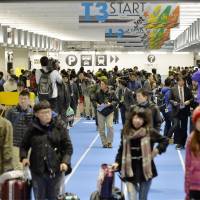 Passengers fill the new terminal at Narita International Airport on Wednesday following its opening. It is intended to become a hub for low-cost carriers. | KYODO