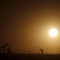 Pump jacks are seen at sunrise near Bakersfield, California, in October. Years of tight environmental rules improved California air quality so much that the state has not issued a smog alert in a dozen years. But prolonged drought and warmer temperatures have triggered a spike in the number of winter days thick with soot and dirt, while summer days have been marred by smog. Recent studies suggest an excess of smog is drifting in to the state from Asia and other parts of the world. | REUTERS