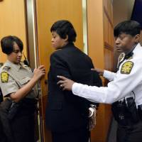 Former Deerwood Academy Assistant Principal Tabeeka Jordan is led to a holding cell after a jury found her guilty in the Atlanta Public Schools test-cheating trial Wednesday in Atlanta. Jordan and 10 other former Atlanta Public Schools educators accused of participating in a test cheating conspiracy that drew nationwide attention were convicted Wednesday of racketeering charges. | AP