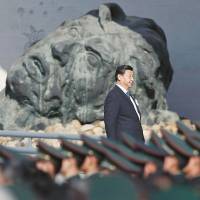 Chinese President Xi Jinping (center) and other leaders attend a memorial ceremony at the Nanjing Massacre Memorial Hall in Nanjing on Dec. 13. China\'s central government is trying hard to get world leaders to attend events marking the 70th anniversary of the end of World War II that will be held in Beijing this year. | REUTERS