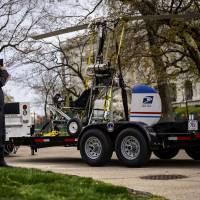 A man takes pictures of a gyrocopter that was flown onto the grounds of the U.S. Capitol as it is towed from the west front lawn April 15. | REUTERS