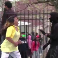 Toya Graham (left) yells at a rioter she recognized as her 16-year-old son, in a video grab. \"I\'m a no-tolerant mother,\" the single mother of six later told CBS News. | AP / WSVN-TV / TWITTER