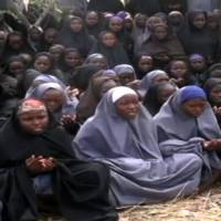 Girls, wearing the full-length hijab and praying in an undisclosed rural location, are seen in a video taken last May by Boko Haram militants who abducted them. | AFP