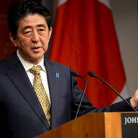 Prime Minister Shinzo Abe answers questions at the John F. Kennedy School of Government at Harvard University in Cambridge, Massachusetts, on Monday. | REUTERS