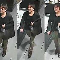 Surveillance camera images released by the Gunma Prefectural Police investigating a string of sulfuric acid attacks in Gunma Prefecture since last week show a man carrying a black bag. | KYODO