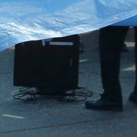 A drone, which carried a small camera and a small plastic bottle, is seen on the roof of the prime minister’s office in Tokyo on Wednesday.  | REUTERS