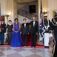 President Barack Obama and first lady Michelle Obama with Prime Minister Shinzo Abe and his wife Akie Abe, pose for the Official Photo at the Grand Staircase before the start of the State Dinner at the White House on Tuesday. In earlier welcoming the Abes, Obama noted karaoke and anime are among things Japanese that Americans are thankful for. | AP