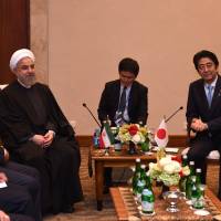 Iranian President Hassan Rouhani and Prime Minister Shinzo Abe hold a bilateral meeting on the sidelines of the Asian Africa Conference in Jakarta on Wednesday. | ROMEO GACAD / POOL / AFP-JIJI