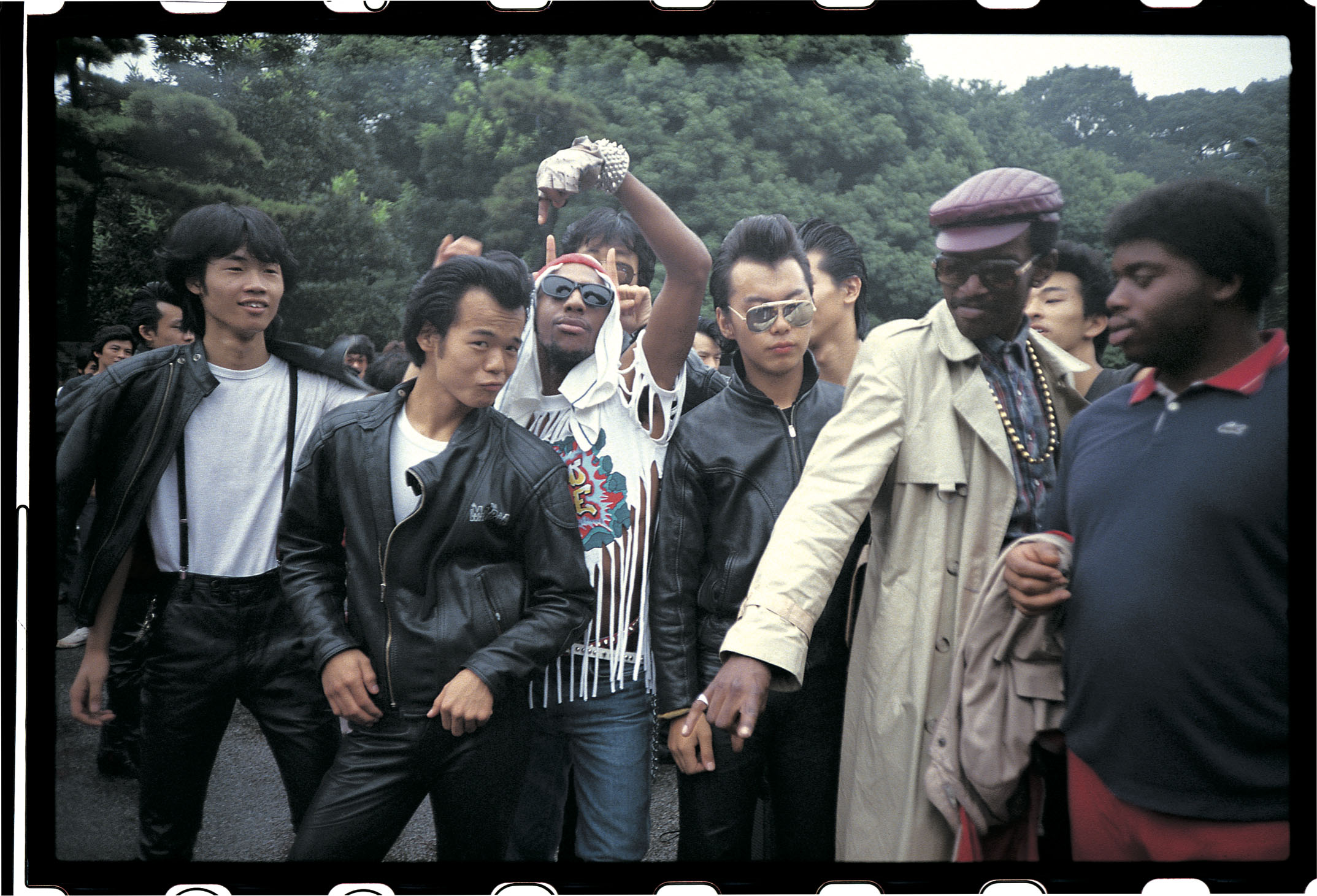 Rockers and rappers: Busy Bee and Fab 5 Freddy from 'Wild Style' mingle with rockers in Tokyo's Yoyogi Park after overcoming initial concerns the leather-clad group were gang members. | CHARLIE AHEARN