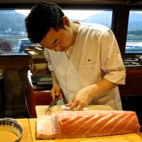 Chef Toshio Matsuno slices up servings of otoro tuna at Tempura Matsu. | ROBBIE SWINNERTON