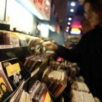 Top finds: A customer browses through records in London. | BLOOMBERG