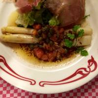 A theatrical side: Two thick white fingers of asparagus in a saute of butter sauce, served with bacon at Bistrot d’Anjou. Japan's French bistro dining keeps the focus on the food