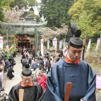 Tsunenari Tokugawa (left), a descendant of Tokugawa Ieyasu (1543-1616), climbs steps at Shizuoka\'s Kunozan Toshogu Shrine, where the Edo Period shogun is entombed. He was taking part Friday in a ceremony marking 400 years since Ieyasu\'s death. About a dozen descendants, as well as some 300 people with other connections, took part. | KYODO