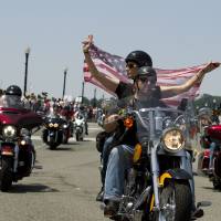 Participants in the Rolling Thunder annual motorcycle rally ride past Arlington memorial bridge during the parade ahead of Memorial Day in Washington on Sunday. | AP