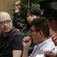 Yi Zhenxing (left) chats with employees at his office in Beijing on Tuesday. Yi, who goes by the Web name of Yi Xiaoxing, was noticed by a team at Tudou when his short video clips became popular. That led to him forming a company and making the Web series “Surprise,” about a young man for whom things often go wrong. Booming China film industry mines Internet for oddball talent