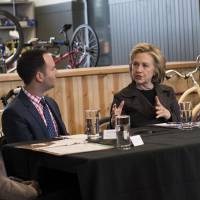 Hillary Rodham Clinton speaks Tuesday during a small business roundtable discussion with Donna Sorensen (left), chair of Cedar Rapids Bank and Trust, Brad Magg (second from left), owner of Goldie\'s Ice Cream Shoppe and Magg Family Catering, Denita Gadson (second from right), owner of i-Gus Consulting, and Brent Johnson, owner of Bike Tech at Bike Tech in Cedar Falls, Iowa. Clinton\'s State Department emails must be made public on a rolling basis instead of waiting for a mass release in January, a federal judge ruled, rejecting a government proposal for releasing about 55,000 pages of the correspondence early next year. | BLOOMBERG