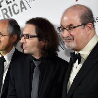 Gerard Biard (left), recently appointed editor-in-chief of the Paris-based satirical weekly Charlie Hebdo, critic Jean-Baptiste Thoret (center) and author Salman Rushdie attend the annual PEN American Center Literary Gala on Tuesday at the American Museum of Natural History in New York, where the freedom of expression award is being given to the Charlie Hebdo magazine. | AFP-JIJI