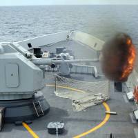 The Chinese frigate Yulin fires a cannon during Exercise Maritime Cooperation 2015 involving the Singapore and Chinese navies in the South China Sea on Sunday. | AP