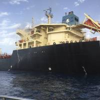 Smoke rises from the oil tanker Anwar Afriqya after a Libyan warplane attacked the tanker in Sirte, Libya, Sunday. | REUTERS