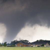 A tornado passes near Halstead, Kansas, Wednesday. A swath of the Great Plains is under a tornado watch, including parts of North Texas, Oklahoma, Kansas and Nebraska. | TRAVIS HEYING / THE WICHITA EAGLE VIA AP