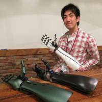 Exiii Inc. co-founder and CEO Genta Kondo shows off prototypes of the handiii robotic prosthetic arm. | KAZUAKI NAGATA