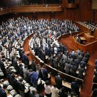 Lawmakers pass a bill that would amend the law assigning personal identification numbers, during a Lower House plenary session on Thursday. | KYODO