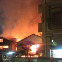 Two hostels burn in Kawasaki at 2:45 a.m. on Sunday. | KYODO