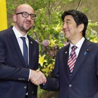 Belgium\'s Prime Minister Charles Michel shakes hands with Prime Minister Shinzo Abe at the prime minister\'s office in Tokyo on Wednesday prior to their talks. Michel arrived in Tokyo on Monday for a four-day stay, on his first visit since taking office last October. | KYODO