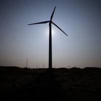 A turbine made by DeWind Co. stands at an EcoPower Co. wind farm in Kamisu, Ibaraki Prefecture, in August 2013. | BLOOMBERG