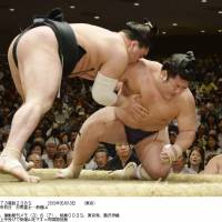 Quick work: Harumafuji drops Tochiozan on Sunday at the Summer Grand Sumo Tournament in Tokyo. | KAZ NAGATSUKA