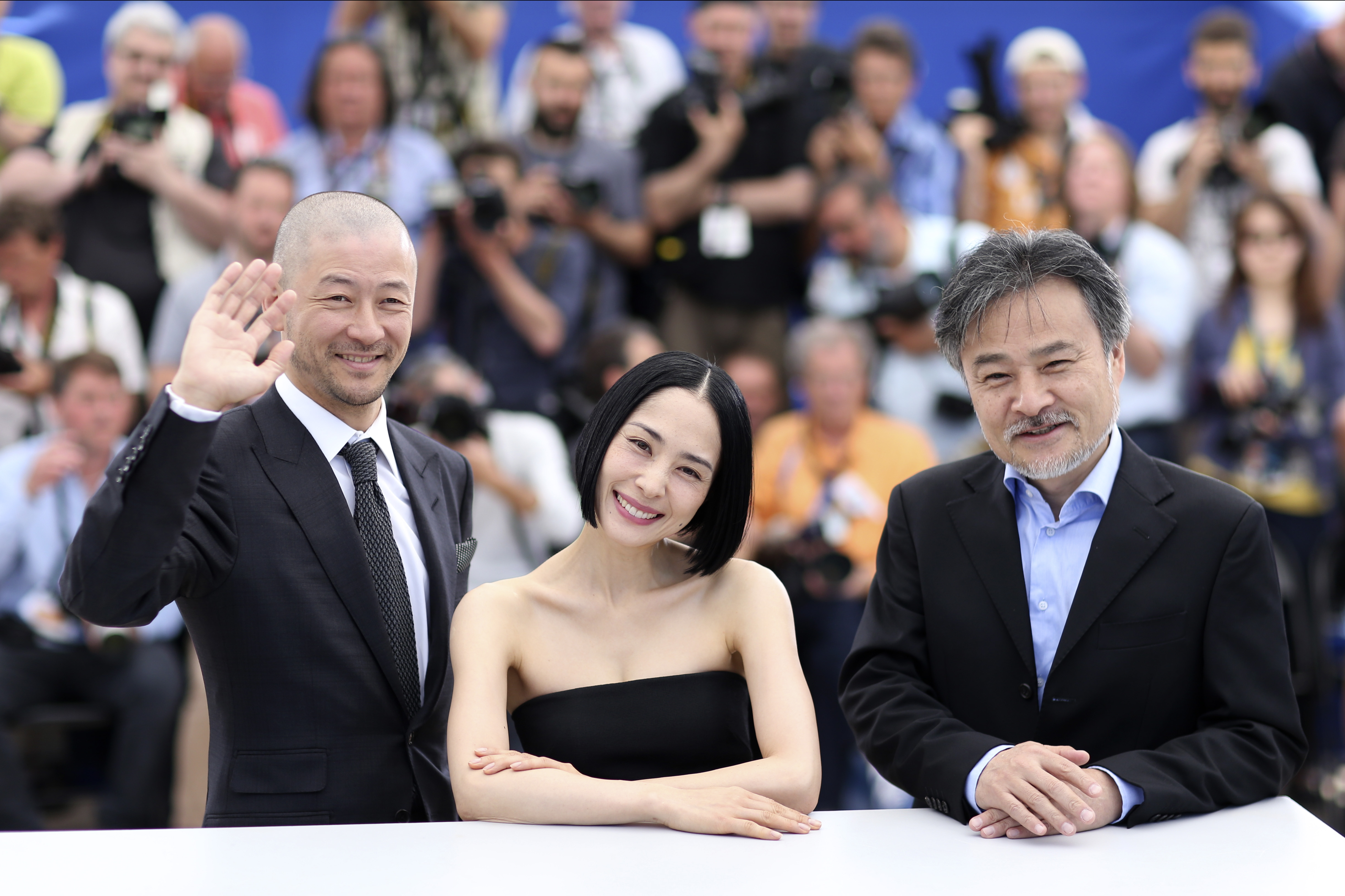Winning team: Director Kiyoshi Kurosawa poses beside Tadanobu Asano and Eri Fukatsu, the stars of his film 'Kishibe no Tabi' ('Journey to the Shore'), at the 68th Cannes film festival. | AP / THIBAULT CAMUS