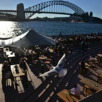 Trouble maker: People eat outside on a sunny autumn day in Sydney on May 12. Australia\'s Bureau of Meteorology has warned the El Nino weather phenomenon, which can spark deadly and costly climate extremes, will pack a punch this year. | AFP-JIJI