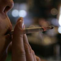 Health threat?: A women smokes a cigarette at a bar in Harrisburg, Pennsylvania. Is nicotine addiction bad for your health?