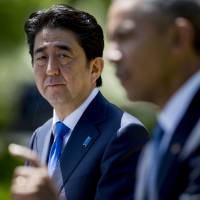 Brothers in arms: Prime Minister Shinzo Abe looks on as U.S. President Barack Obama speaks during a joint news conference in the Rose Garden at the White House on April 28. | BLOOMBERG