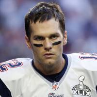 New England Patriots quarterback Tom Brady warms up ahead of the start of the NFL Super Bowl XLIX football game against the Seattle Seahawks in Glendale, Arizona, in this file photo taken Feb. 1. The National Football League on Monday said it suspended star quarterback Brady for the first four games of next season and fined the New England Patriots $1 million for its role in \"Deflategate.\" | REUTERS