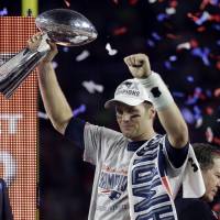 New England Patriots quarterback Tom Brady holds up the Vince Lombardi Trophy after the Patriots defeated the Seattle Seahawks 28-24 in NFL Super Bowl XLIX in Glendale, Arizona on Feb. 1. The NFL Monday  suspended Super Bowl MVP Brady for the first four games of the season. | AP