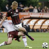 Hungry for more: AC Milan\'s Keisuke Honda (right) is tackled by Torino\'s Cristian Molinaro during Milan\'s 3-0 win on Sunday. | AP