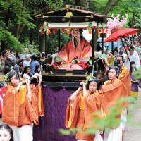 A parade passes through Shimogamo Shrine in Kyoto on Friday during the Aoi Festival, one of the city\'s three major festivals. It began around 1,400 years ago, when people prayed for a healthy grain harvest after repeated crop failures. | KYODO