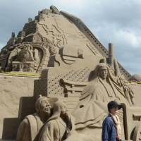 A shinkansen and a steam locomotive are portrayed by a sand sculpture at Sand Festa on Friday in Fukiagehama, near Minamisatsuma, Kagoshima Prefecture. The annual event, which opened the same day, runs till the end of the month. | KYODO
