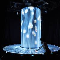 Scene II Diversity area features a digitally projected waterfall where about 1,000 square panels on Japanese food culture are floating; visitors can touch their smartphones to square to download more information through a special app. | JAPAN PAVILION PR