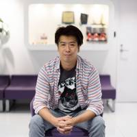 Kazuki Morishita, president and chief executive officer of GungHo Online Entertainment Inc., poses after an interview in Tokyo on Wednesday. GungHo plans to strike partnerships with third-party game developers and share its recipe for success, as the maker of the world\'s highest-grossing smartphone title begins to expand into publishing. | BLOOMBERG