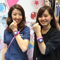 Sega Toys Co. staff pose with the Jewel Watch, a toy for girls inspired by the Apple Watch, at International Tokyo Toy Show 2015 on Thursday. | YOSHIAKI MIURA
