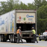 New York State Troopers search a truck at a check point near Dannemora, New York, on Monday, looking for two convicted murderers who broke out of a nearby prison. | REUTERS
