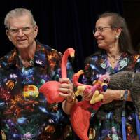 In this 2012 photo artist Don Featherstone, 1996 Ig Nobel Prize winner and creator of the plastic pink flamingo lawn ornament, poses with his wife, Nancy, while being honored as a past recipient during a performance at the Ig Nobel Prize ceremony at Harvard University, in Cambridge, Massachusetts. Featherstone died Monday at an elder care facility in Fitchburg. He was 79. | AP